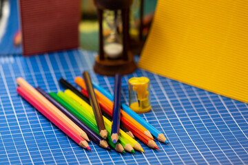 Colored pencils, sharpener and cardboard