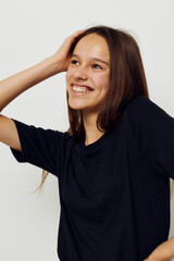 beautiful girl in a black t-shirt hand gesture fun isolated background