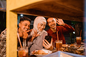 muslim friend having iftar dinner and making a video call