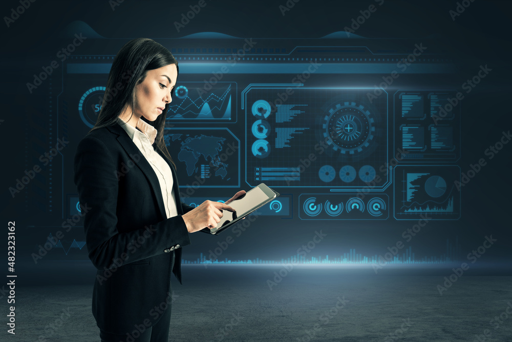 Poster attractive young european businesswoman using tablet while standing on dark background with glowing 