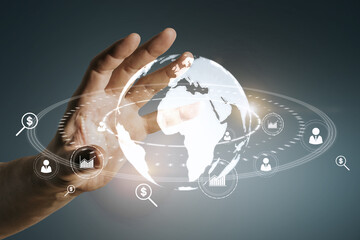 Close up of man hand holding glowing social globe hologram on blue background. Information, data and communication concept.