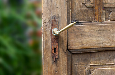 Old teak wood door with rusty door handle