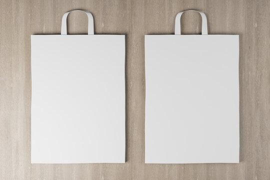 Close up of empty white paper bag on wooden backdrop. Mock up place for your advertisement or logo. 3D Rendering.