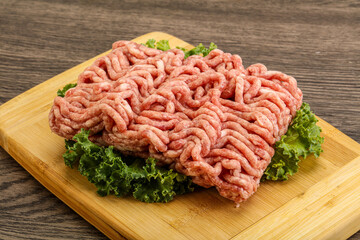 Raw pork minced meat over board