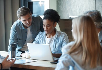 Obraz premium Smiling diverse colleagues discuss financial statistics, coworkers have cooperating working together at office meeting