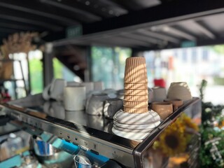 Paper coffee cup on the Coffee machine in cafe. 