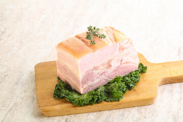 Cut of pork bacon over board