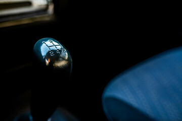 Manual gear shift knob close up shot on an old japanese 4 wd car, shallow depth of field, space for text.