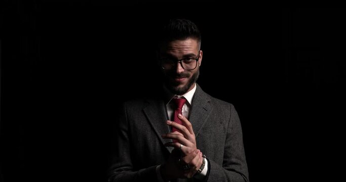businessman rubbing his palms and having a malefic smile on his face