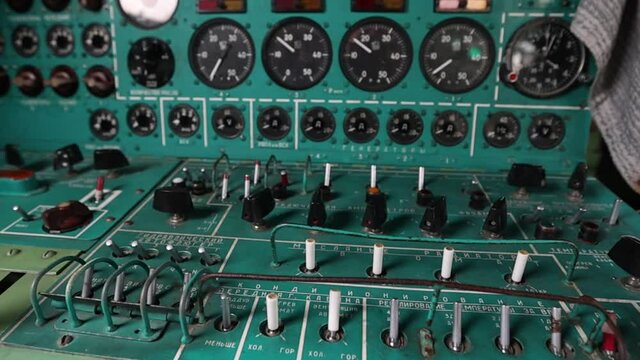 A place for a flight mechanic with all sensors and toggle switches in the Soviet strategic turboprop bomber Tu-95. The cockpit is inside. Natural light. Full HD.120 fps.