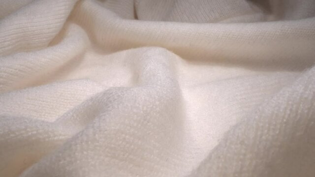 The texture of a white soft warm cozy woolen knitted sweater