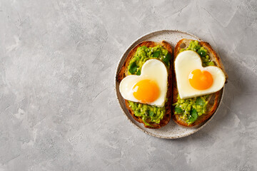 Healthy breakfast with eggs hearts and cup of coffee on grey background