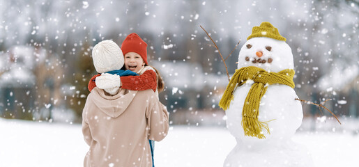 Mother and child girl on a winter walk