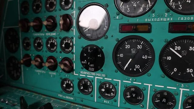 A place for a flight mechanic with all sensors and toggle switches in the Soviet strategic turboprop bomber Tu-95. The cockpit is inside. Natural light. Full HD.120 fps.