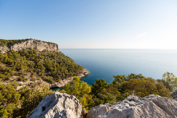 beautiful view of the rocky mountains next to the sea in summer