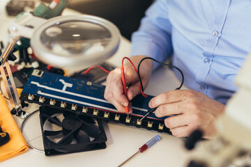 Engineer fixing broken computer equipment. Electronic repair shop, technology development concept