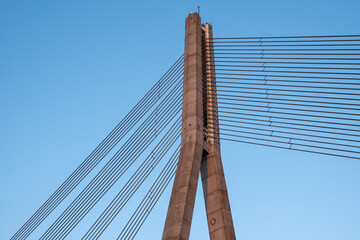 Fototapeta na wymiar Fragment of suspension bridge with steel cables