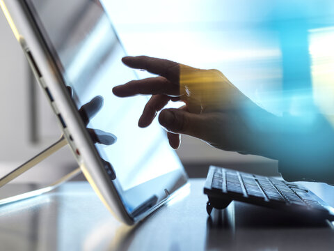 Hand of engineer touching tablet PC screen