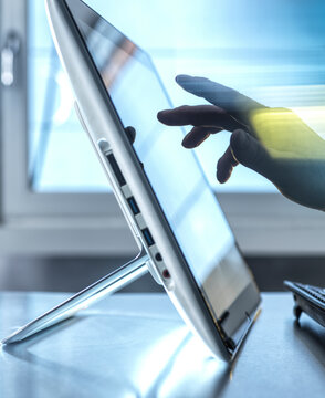 Technician touching tablet PC screen