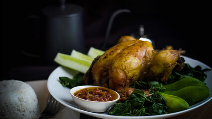 Whole fried chicken with chili sauce and vegetables