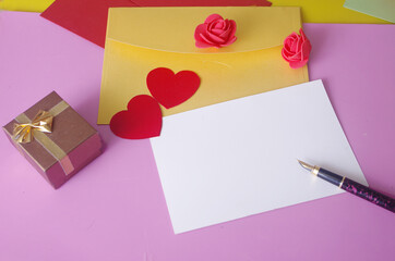 Love letter. Envelopes, empty blank, red hearts, fountain pen on a colored background. Place for an inscription.