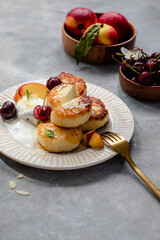 cheese pancakes with cherry, nectarine, yougurt.  breakfast table