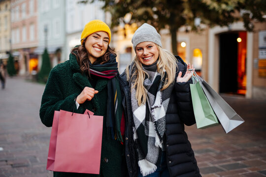 Cheerful women with shopping bags at market