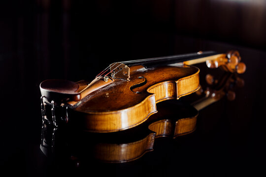 Studio shot of violin lying against black background