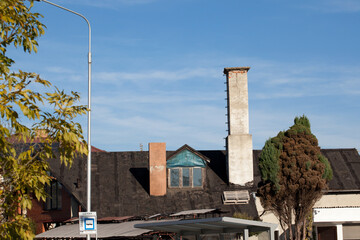 Roof covered with old tar paper and part of a bus stop.