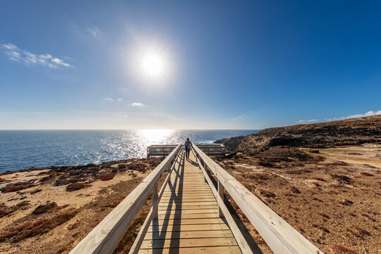 Australia, Victoria, Cape Bridgewater, Sun shining over boardwalk leading to Bridgewater Blowholes