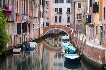 Fototapeta premium Small canal and bridge between houses in Venice, Italy