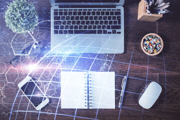 Double exposure of map hologram drawing over study table background with computer. Concept of international network. Top view.