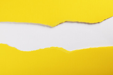 Yellow paper with torn edges isolated with white colored paper background inside. Good paper texture