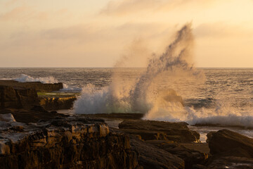 Wave breaking on the rocky coastline.