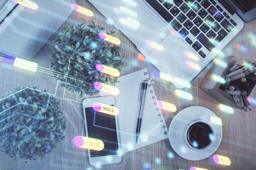 Double exposure of technology theme drawing over work table desktop. Top view. Global data analysis concept.