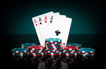 Chips and aces cards. Playing cards in poker with with four of a kind or quads combination. Succeed and win in casino