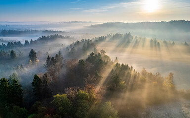 Drone view of sun rising over fog shrouded Welzheim Forest