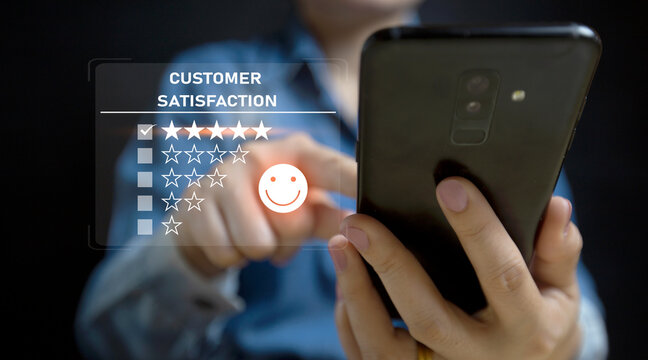 Satisfied customer experience concept, happy business customer with happy face on smartphone screen, good review, great service, likes, likes, very good quality, high scores, good social media. - Powered by Adobe