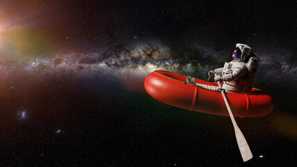 astronaut in rubber boat, surreal space background  © dottedyeti