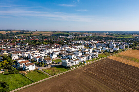 Germany, Baden-Wurttemberg, Sindelfingen, Aerial view of plowed field in front of new development area