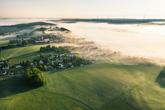 Germany, Bavaria, Berg, Aerial view of countryside village at foggy springtime dawn