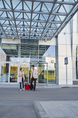 Female with boarding documents and man near airport