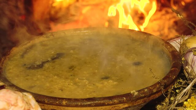 Ukrainian traditional dish
Christmas kulish cooked on a fire in a clay plate against the background of fire