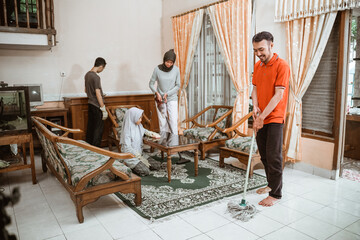 All Asian family members together clean the house