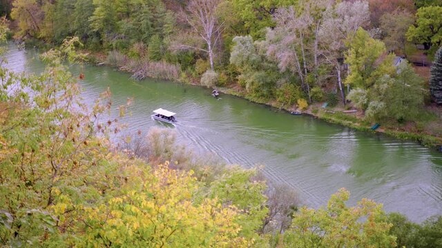 Boat with tent mooves by river