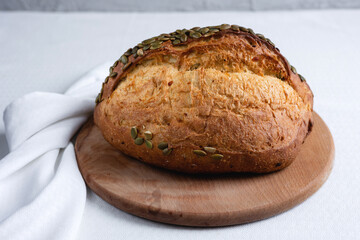 Rye bread on a board on a white tablecloth background