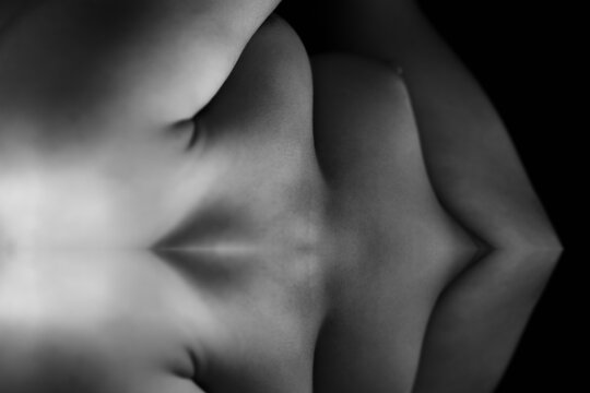 Naked woman breast. Black and white.