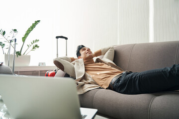 Male dreaming on sofa in room of hotel