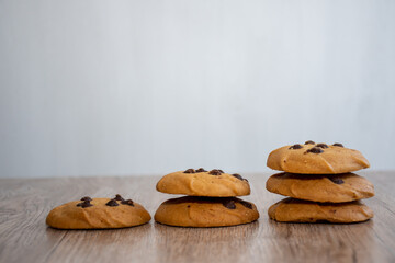 Classic chocolate chip cookies against wooden background. Concept of dessert, baking, and sweet food