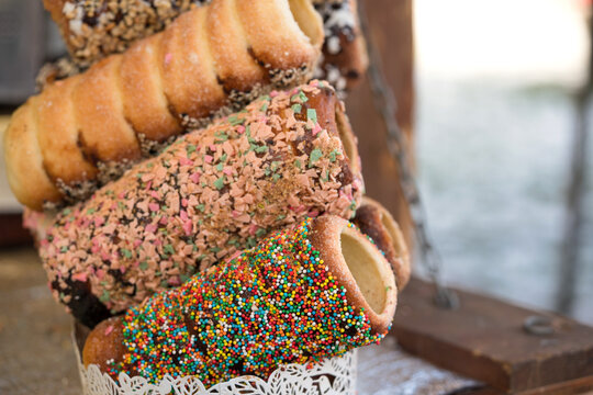 Fresh cooked traditional Czech trdlo or trdelnik, at street food market stall. National street food in Czech Republic and Hungary. Hungarian kurtoskalacs
